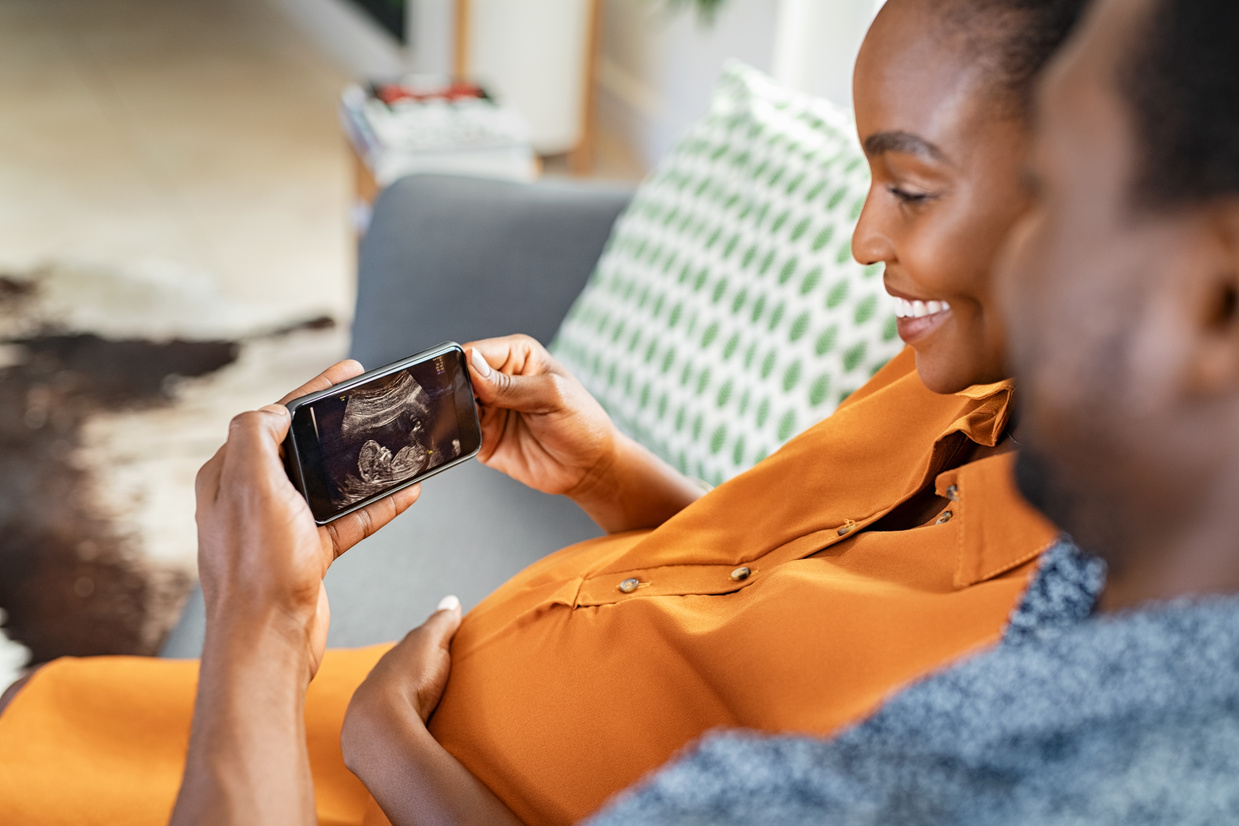 Pregnant Black Couple Watching Ultrasound on Phone